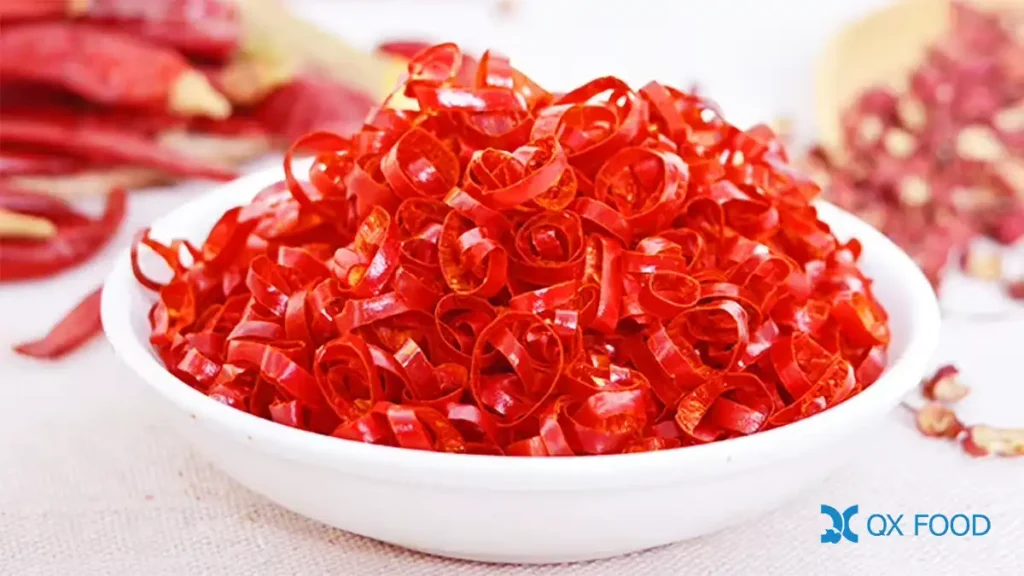 CR-C16 thin dried chili rings floating on instant noodle cup broth -- delicate paper-thin red rings among noodles