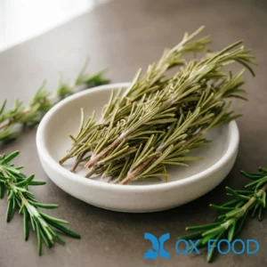 Dried rosemary sprigs PRS-K39 whole light green herb branches arranged in white ceramic sample dish on dark surface with fresh rosemary sprigs nearby
