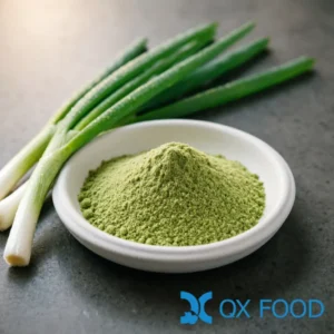 Scallion powder SLP-B05 fine green powder in white ceramic sample dish on dark surface with fresh scallion stalks scattered nearby